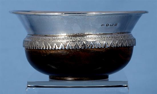 A George V Arts & Crafts planished silver mounted oak mazer, by Albert Edward Jones, Diameter 142mm height 2 ¾”/67mm